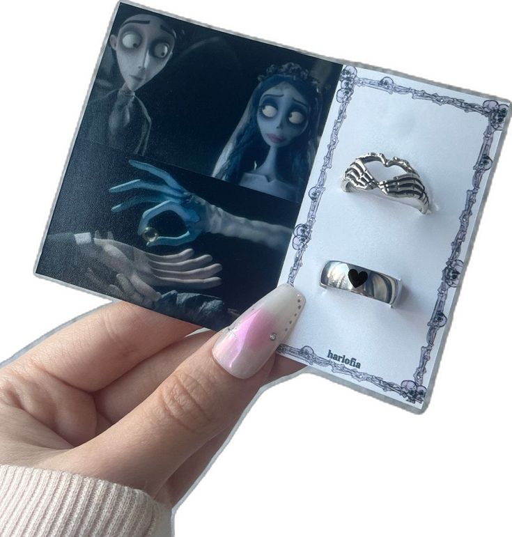 someone is holding out their ring set in front of an image of corpse from corpse