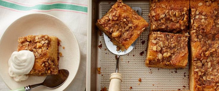 a pan filled with baked goods next to a white plate and spoon on top of a table