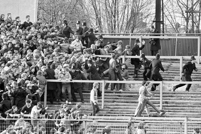 an old black and white photo of people in the stands