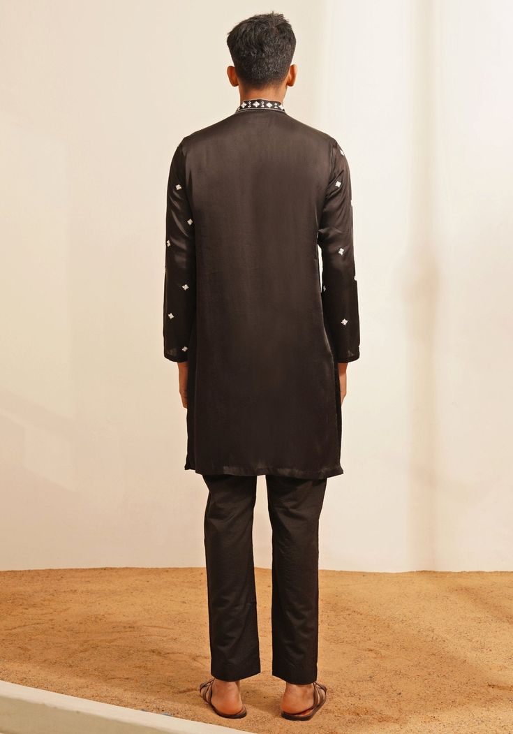 Features a Black Mirrorwork Kurta Set intricate with a chinese collar and polished metallic silver buttons. Kurta features delicate hand embroidered motifs for a festive look and is paired with matching pants. Perfect for Cocktail or Sangeet party. Composition : Chanderi Silk Care: Dry Clean Only and Vacuum Storage This product can be customized for sleeves, length and colour Delivery : 4-6 weeks as the product is hand crafted. Check Size Guide or choose MySize for free customisation (All Sizes above XL can be made at 15% additional cost) For more information and sizes please contact fabiliciousfashion@gmail.com or visit our Copenhagen studio. About the Designer : Shreyansh, a distinguished designer label specializing in luxurious ethnic menswear for weddings. The collections feature elega Formal Bandhgala With Mirror Work, Designer Kurta With Resham Embroidery And Stand Collar, Designer Resham Embroidery Kurta With Stand Collar, Stand Collar Kurta With Resham Embroidery, Eid Party Bandhgala Straight Kurta, Embroidered Silk Bandhgala Straight Kurta, Embroidered Silk Bandhgala Kurta, Silk Embroidered Bandhgala Kurta, Silk Sherwani With Mirror Work For Transitional Season