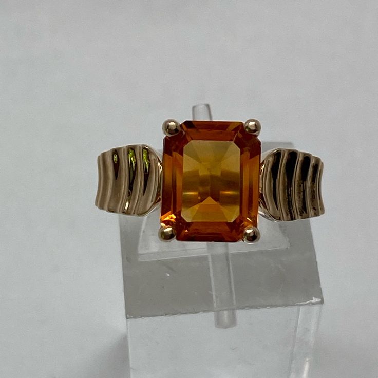 Set Securely In The Center Of This Ring Is A Large Emerald Cut Natural Citrine Gemstone. The Citrine Measures 9.5 X 7.5mm That Weighs Over 2 Carats! It Is Set With Four Prongs And Has Medium/ Dark Golden Orange Color. The Band Has A Concave Ribbed Detailing That Runs Hallway Down The Setting. It Has A Shiny High Polished Finish That Would Be Easy To Size Up Or Down (Locally) Currently A Finger Size 7. The Setting Measures 6mm At The Top And Tapers To A 1.9mm Shank. It Is Solid Yellow Gold And Is Citrine Ring, Natural Citrine, November Birthstone, Citrine Gemstone, Solid Yellow, Womens Jewelry Rings, Solitaire Ring, Emerald Cut, Citrine