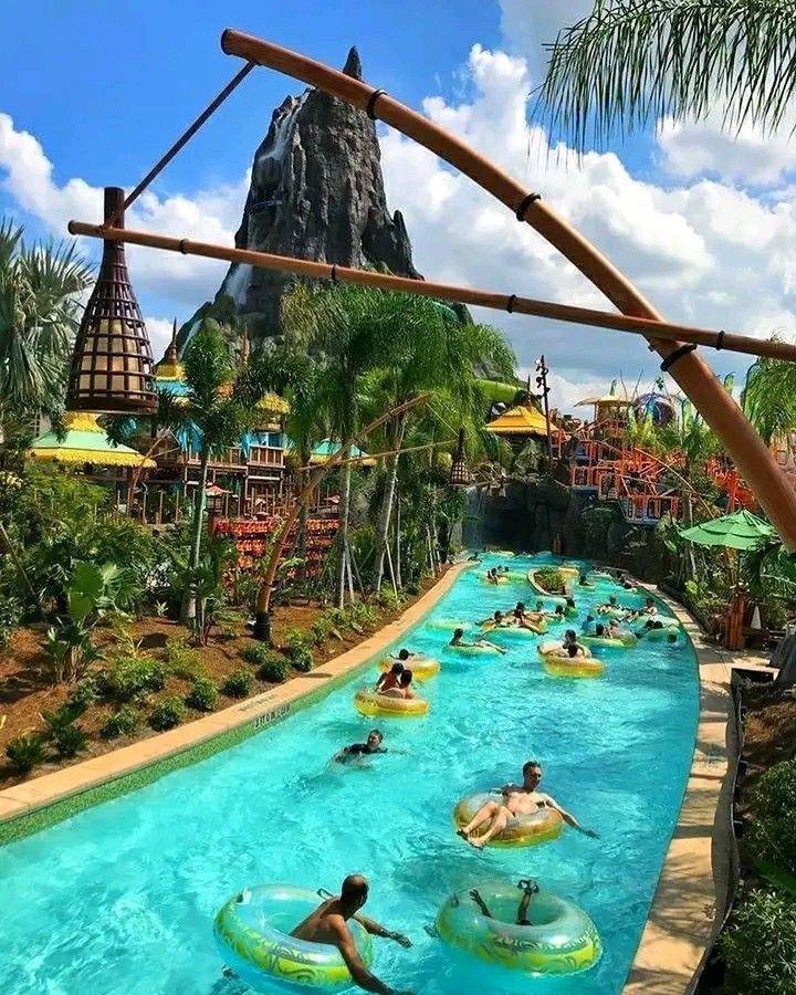 people are in the water at an amusement park