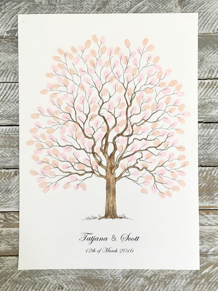 a wedding guest book with a tree on the cover and leaves in pastel colors