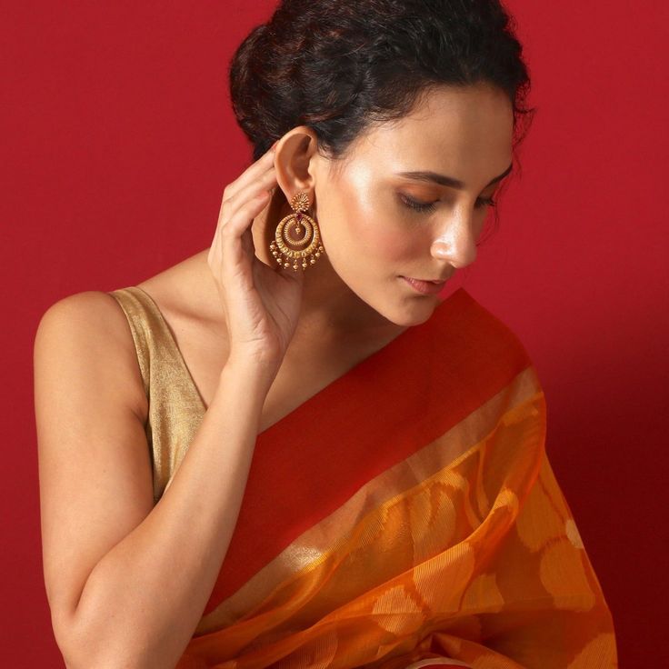 About the Jewelry Looking for earrings that give you a traditional look with a pinch of the modern Indian chic? Kalpa is what you need. Crafted beautifully with various patterns and texture these chaandbalis makes you look elegant in the best way possible. Styling Tip A semi-ethnic attire or a tunic will go perfectly with these earrings. Details & Specifications: Materials used: Brass Metal with Antique Plating Weight - Earrings 21 gm Length - Earrings 6 cm Make it custom Want to make it a custo Buy Earrings Online, Traditional Look, Chandbali Earrings, Earrings Indian, Image Caption, Buy Earrings, Latest Jewellery, Custom Earrings, Online Earrings