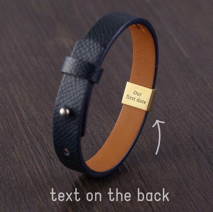 a leather bracelet with an engraved tag on it