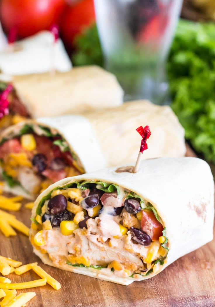 a burrito cut in half on a cutting board