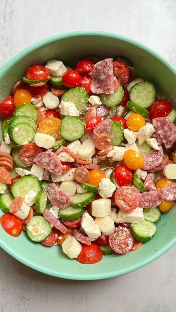 a green bowl filled with lots of different types of food