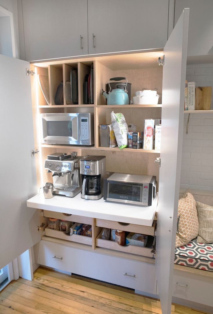 the kitchen is organized and ready to be used as a storage area for coffee makers