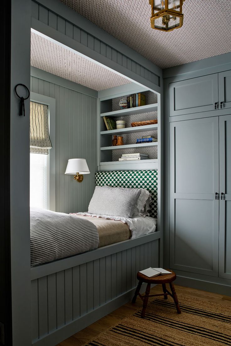 a bedroom with built in bookshelves and a bed