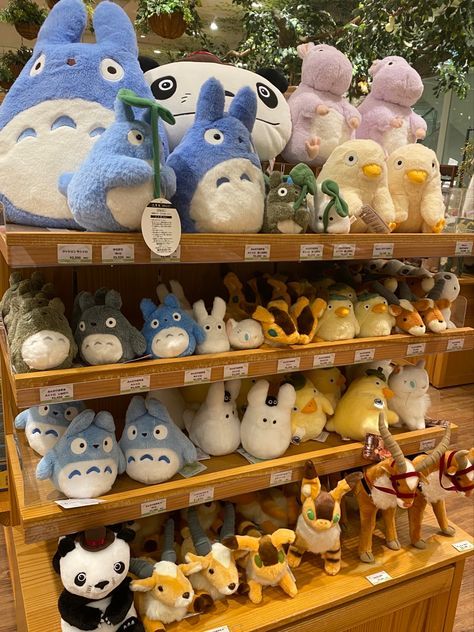 many stuffed animals are on display in a store