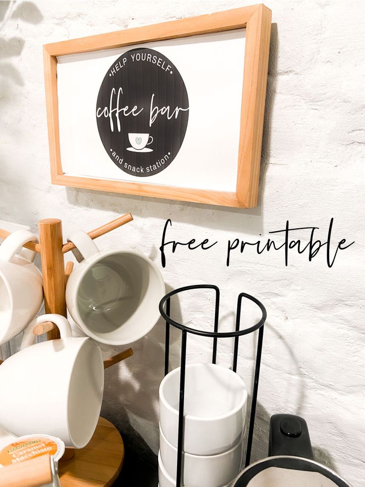 there is a sign that says free printable on the wall next to cups and saucers