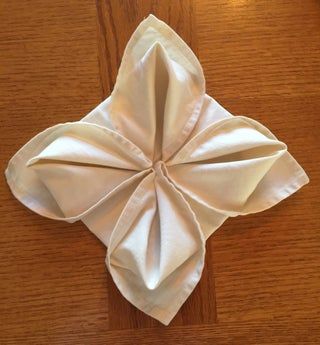 an origami flower on a wooden table