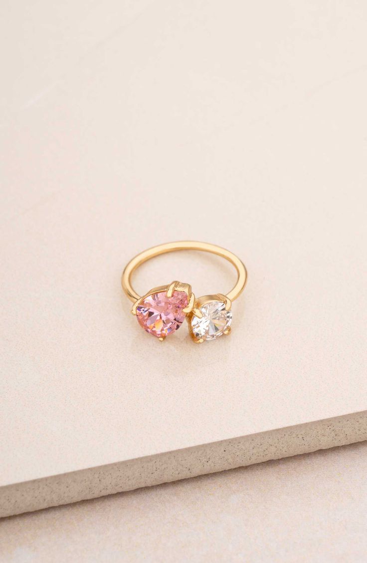 A mixed duo of cubic zirconia shimmers brilliantly atop this slender ring band plated in 18-karat gold. Cubic zirconia/18k-gold plate Imported Pink Gemstone Rings, Colorful Promise Rings, Couple Birthstone Ring, Senior Ring, Eclectic Engagement Rings, Senior Rings, Pink Rings, Fun Rings, Senior Szn