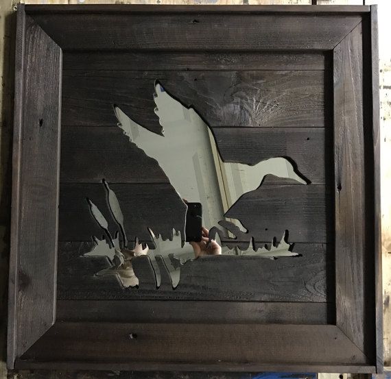 a wooden frame with birds cut out of it