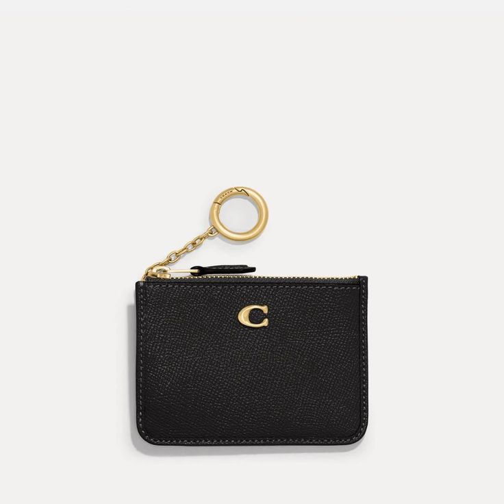 A classic design for life on the go, Coach's Mini ID wallet keeps smaller payment essentials sleekly stowed away. Styled into a compact pocket size, it is made from black crossgrain leather with two card slots, a receipt pocket and a zipped compartment for coins. The ubiquitous 'C' monogram sits at the front in gold-tone detail along with a O-ring purse charm. Classic Coach Card Holder For Travel, Classic Compact Coach Coin Purse, Classic Coach Coin Purse With Coin Pocket, Classic Coach Card Holder, Classic Coach Wallet As Gift, Classic Coach Coin Purse Gift, Classic Coach Coin Purse, Classic Coach Coin Purse As Gift, Classic Coach Card Holder For Everyday Use