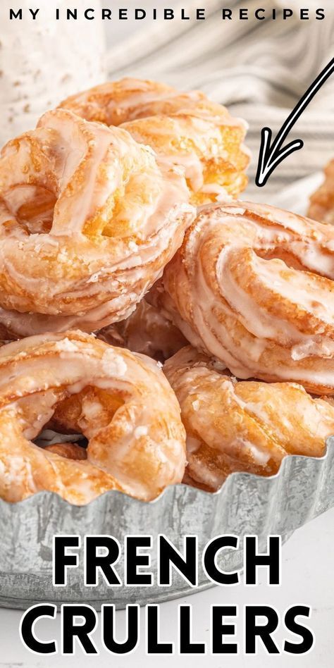 a bunch of doughnuts sitting on top of a metal pan with the words french crullers