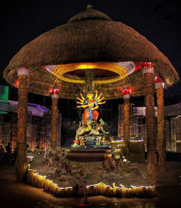 an outdoor gazebo decorated with lights and decorations