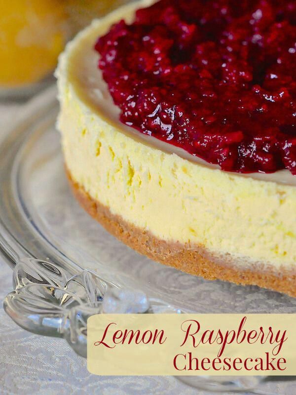 a lemon raspberry cheesecake on a glass plate with a label that says lemon raspberry cheesecake