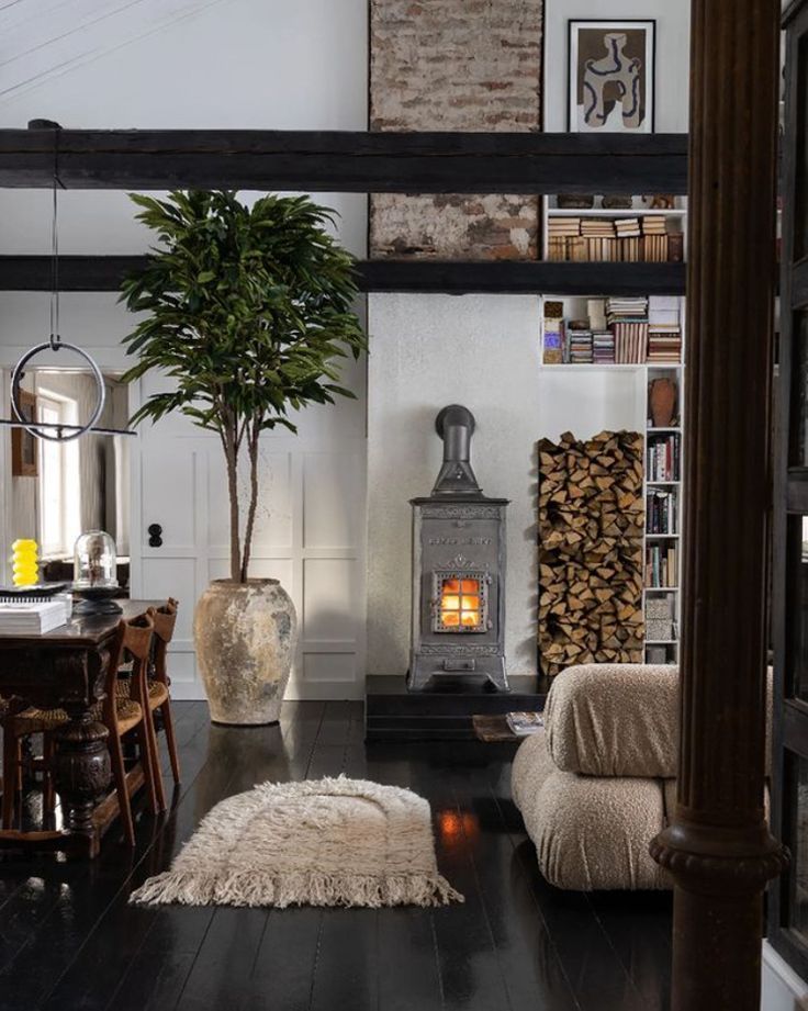 a living room filled with furniture and a fire place next to a book shelf full of books