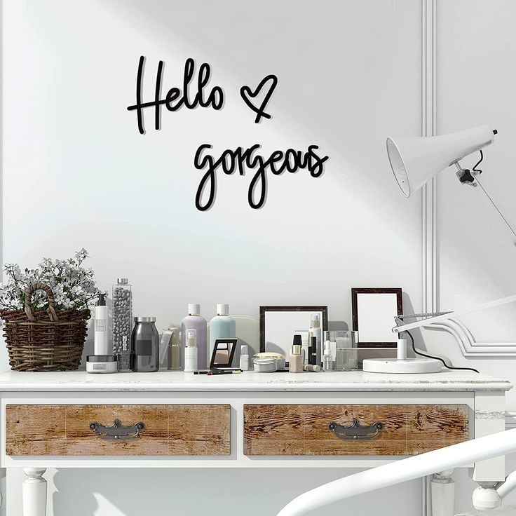 a white desk topped with drawers next to a wall mounted on the side of a wall