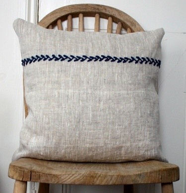 a pillow sitting on top of a wooden chair