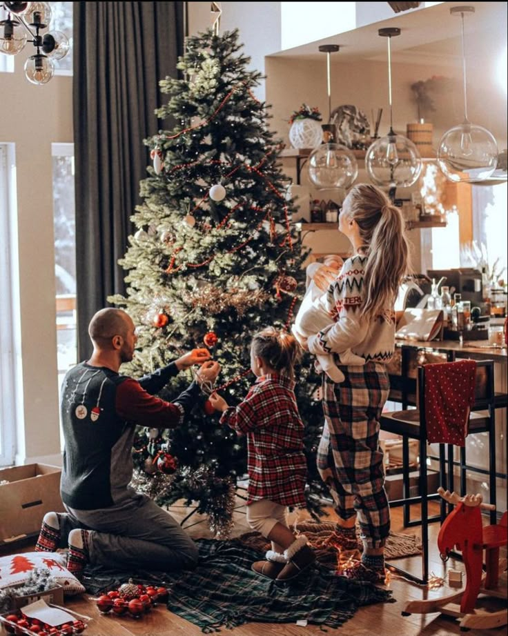 a family decorating a christmas tree in their living room