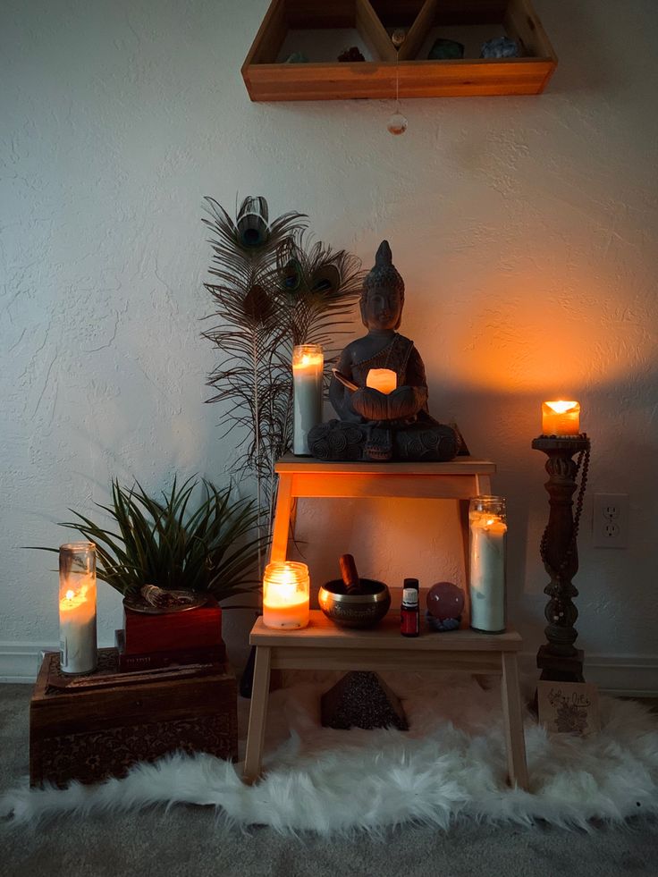 there are many candles and statues on the shelf next to each other in this room