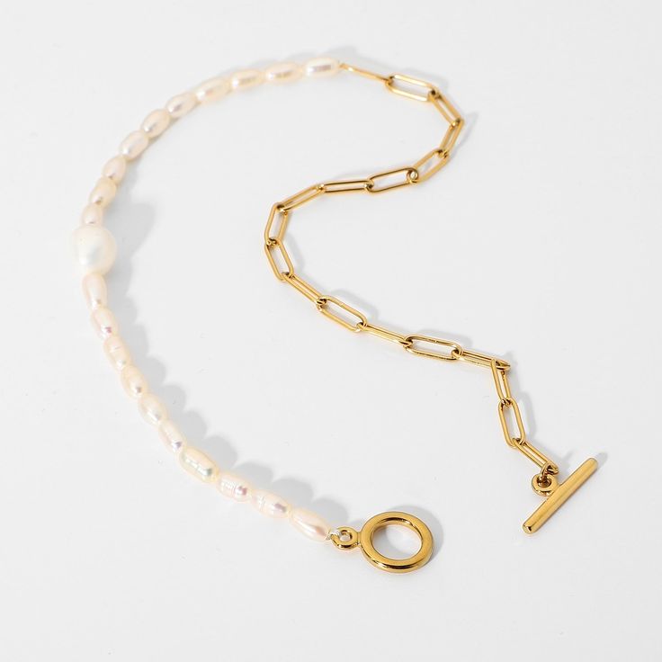 Elevate your style with the 18K Gold Plated Half Pearl Link Bracelet from Koch La Ni. This unique bracelet features a combination of elegant freshwater pearls and a stylish gold-plated link chain, creating a modern yet timeless accessory. Features: Materials: 18K Gold-Plated Stainless Steel, Freshwater Pearls Design: Half pearl and half gold link chain Closure: Toggle clasp for a secure fit Length: 14 inches (36 cm) Additional Features: Hypoallergenic, water-resistant, tarnish-resistant This bracelet is perfect for adding a touch of elegance and sophistication to any outfit. Ideal for both everyday wear and special occasions, the Half Pearl Link Bracelet from Koch La Ni makes an exceptional addition to your jewelry collection or a meaningful gift. Modern Gold Pearl Chain Necklace, Modern Gold Pearl Necklace With Pendant, Modern Gold Pearl Necklace With Pearl Charm, Minimalist Gold Pearl Necklace With Chain, Modern Gold Necklace With Pearl Chain, Gold Link Chain, Pearl Design, Unique Bracelets, Timeless Accessories