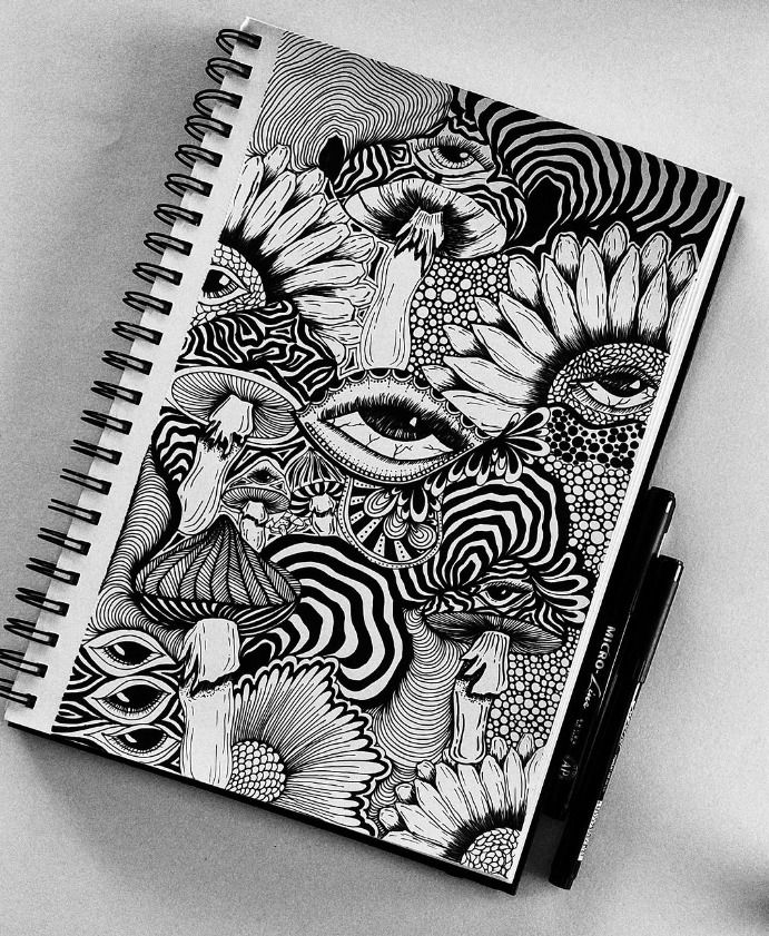 a spiral notebook with black and white drawings on it