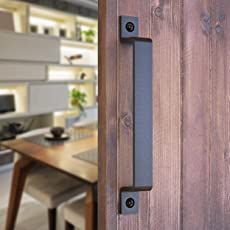 a door handle on a wooden door near a table and chairs in a living room