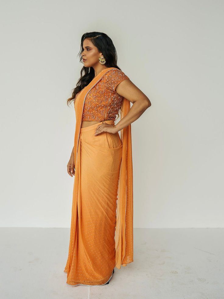 This ombre outfit features a skirt with attached wrap-around draping - all pre-stitched so you can put the outfit together in 30 seconds or less. The piece is paired with a hand-embroidered, cap-sleeve blouse. For a custom color order, please email hello@sani.co. Embroidered Fitted Draped Saree, Embroidered Fitted Saree, Fitted Traditional Draped Skirt For Reception, Festive Fitted Draped Skirt With Traditional Drape, Fitted Draped Skirt For Festive Occasions, Fitted Pre-draped Saree With Cape Sleeves, Fitted Pre-draped Sets, Drape Saree, Cap Sleeves Blouse