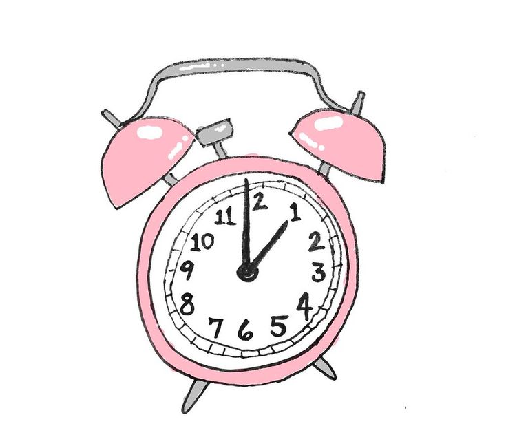 an old fashioned pink alarm clock on a white background