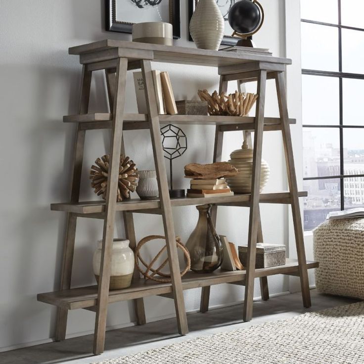 a wooden shelf with books and vases on it