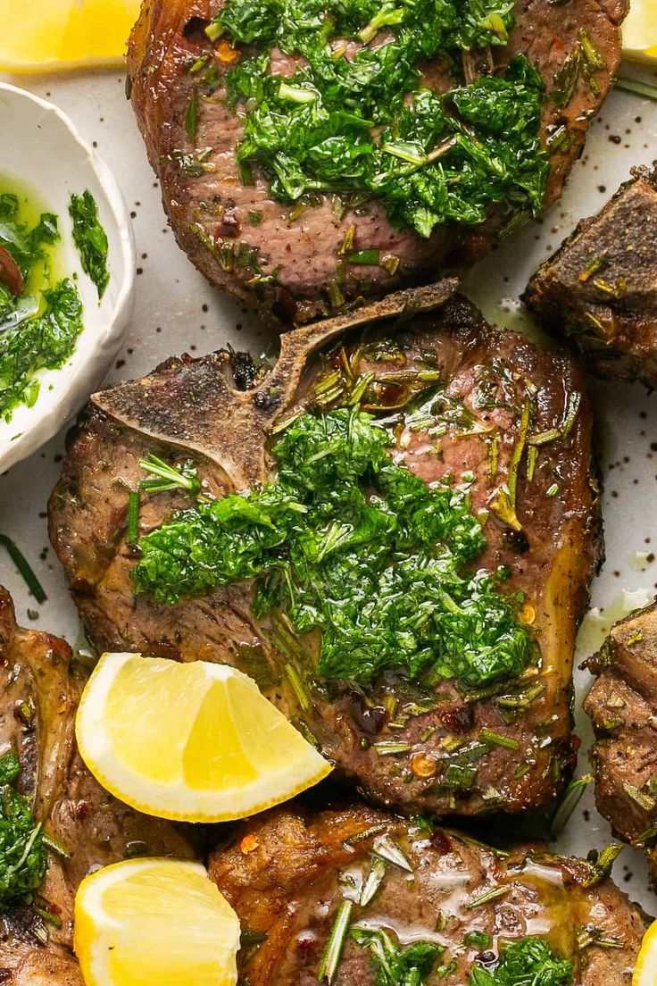 grilled steaks with herbs and lemon slices