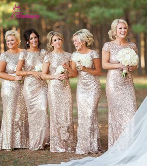 the bride and her bridesmaids are all dressed in gold sequin gowns