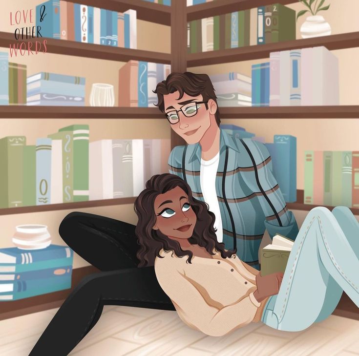 a man and woman sitting on the floor in front of bookshelves with stacks of books behind them