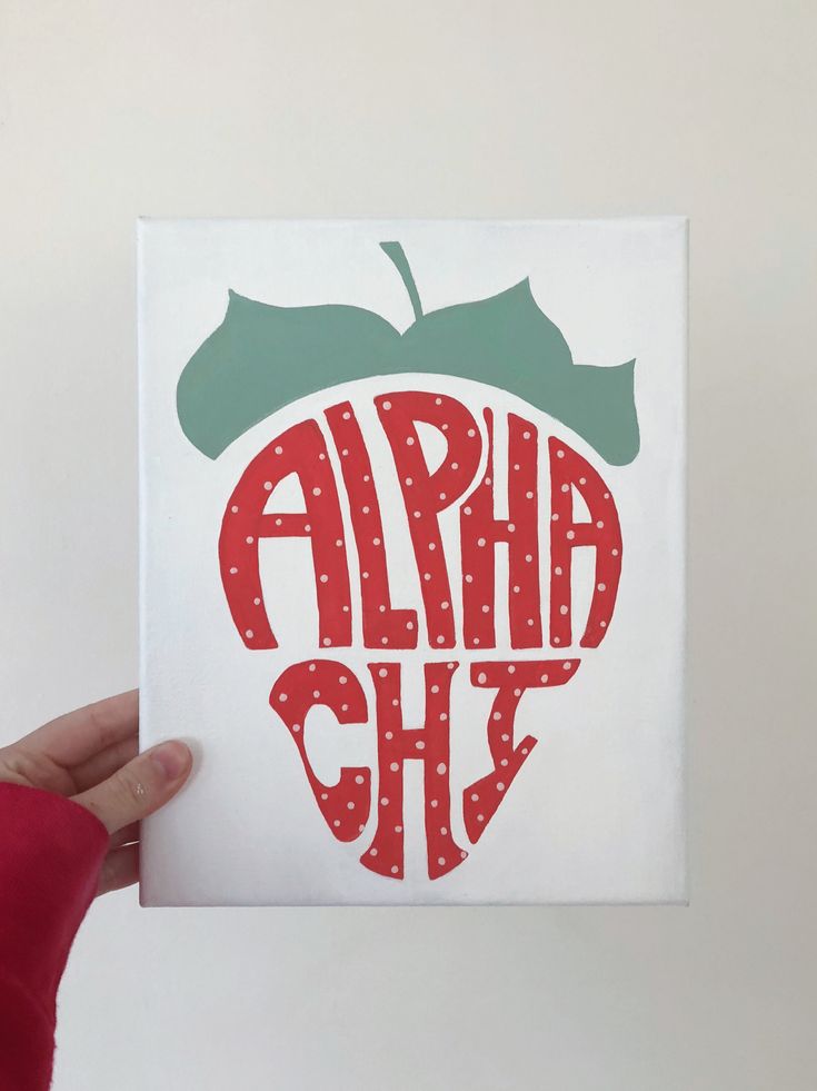 a hand holding up a card with an apple in the middle that says, ahh