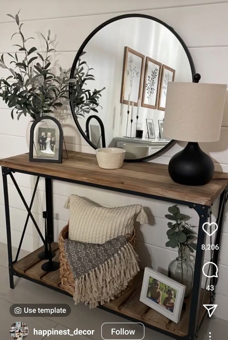 a wooden table topped with a mirror next to a plant