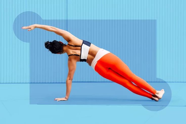 a woman in an orange and white top doing yoga