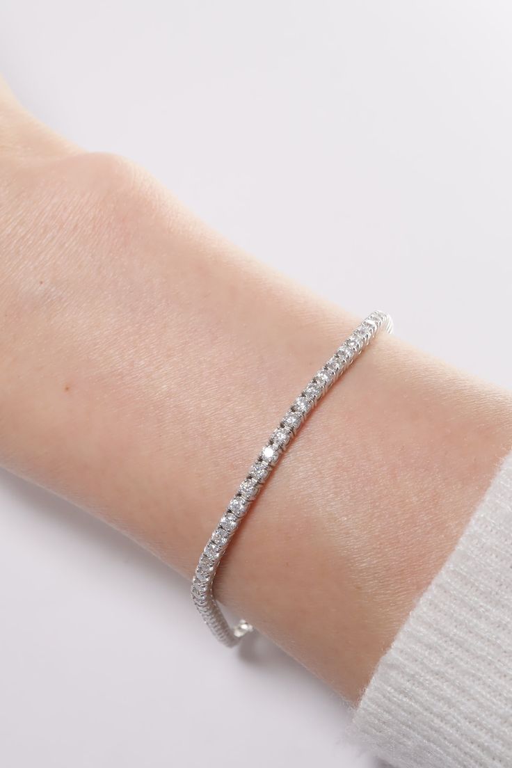 PLX487 Our 2.1mm Lab Rectangle Cut Tennis Bracelet is meticulously handcrafted in Korea, delivering a unique blend of classic and contemporary aesthetics. Made from 14K solid white gold, this bracelet features a tennis design adorned with lab-created rectangle cut stones, providing a timeless and elegant look. This bracelet is perfect for adding a touch of elegance and sparkle to your everyday look or for special occasions. This tennis bracelet also makes a great gift for occasions like birthday Classic White Gold Bangle With Diamond Cut, Modern Platinum Bracelet As Gift, Classic White Gold Diamond Cut Bangle, Elegant White Sterling Silver Bracelet With Prong Setting, Modern Platinum Bracelets For Gifts, Modern Flexible White Gold Diamond Bracelet, Platinum Diamond Cut White Bracelet, Modern Diamond Tennis Bracelet Bangle, Classic Sterling Silver Diamond Cut Bangle