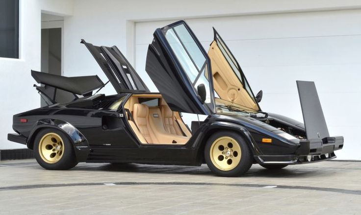 a black sports car with its doors open