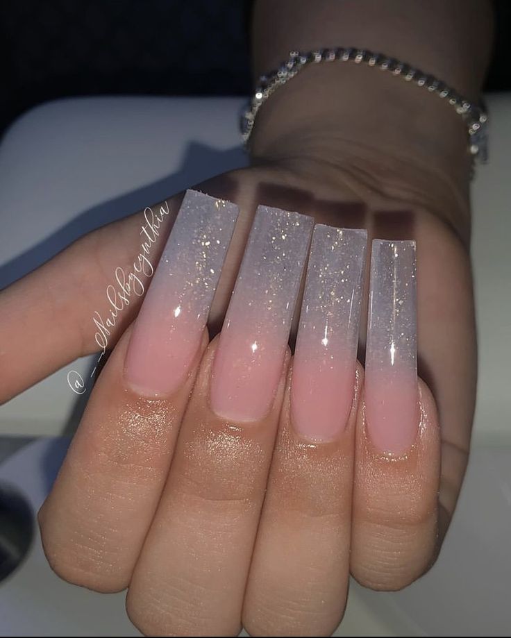 a woman's hand with pink and white ombreed nails