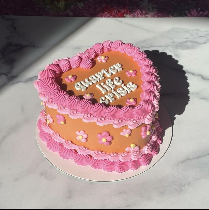 a heart shaped birthday cake on a marble counter top with the words happy birthday written in frosting