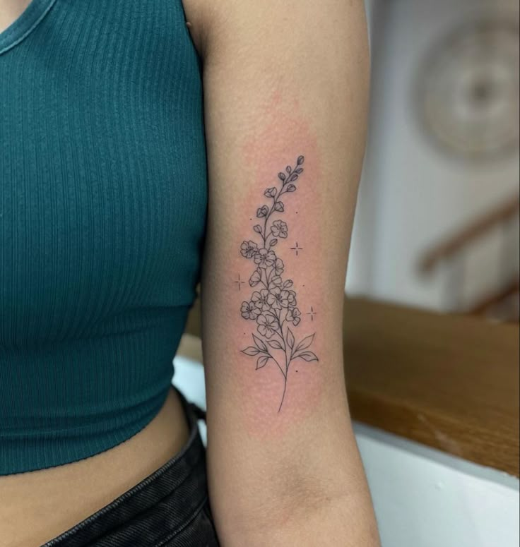 a woman with a flower tattoo on her arm