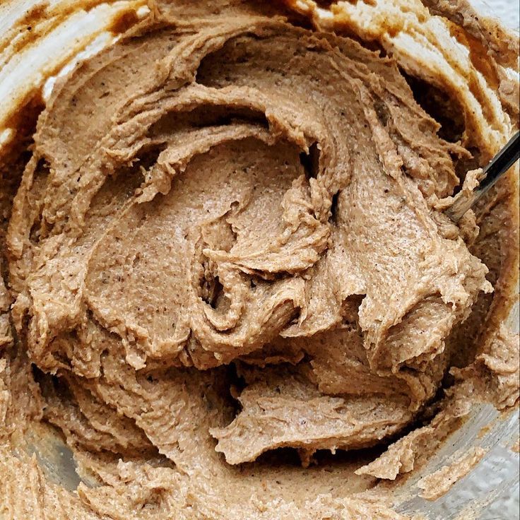 a bowl filled with chocolate frosting on top of a table