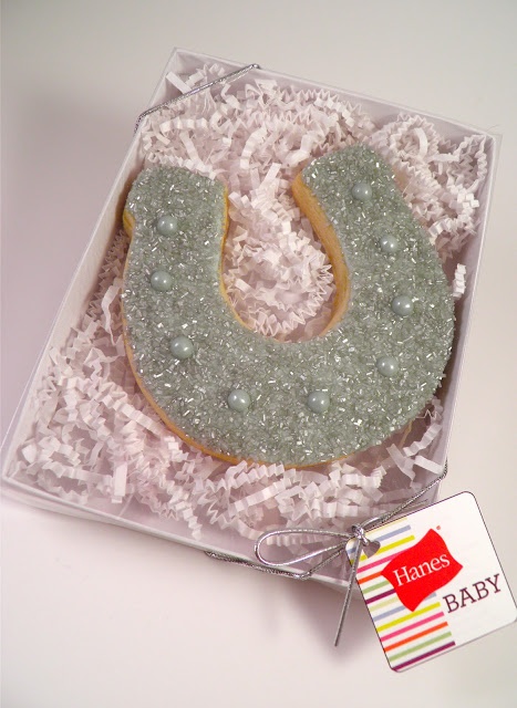 a cookie shaped like a horseshoe sits in a box