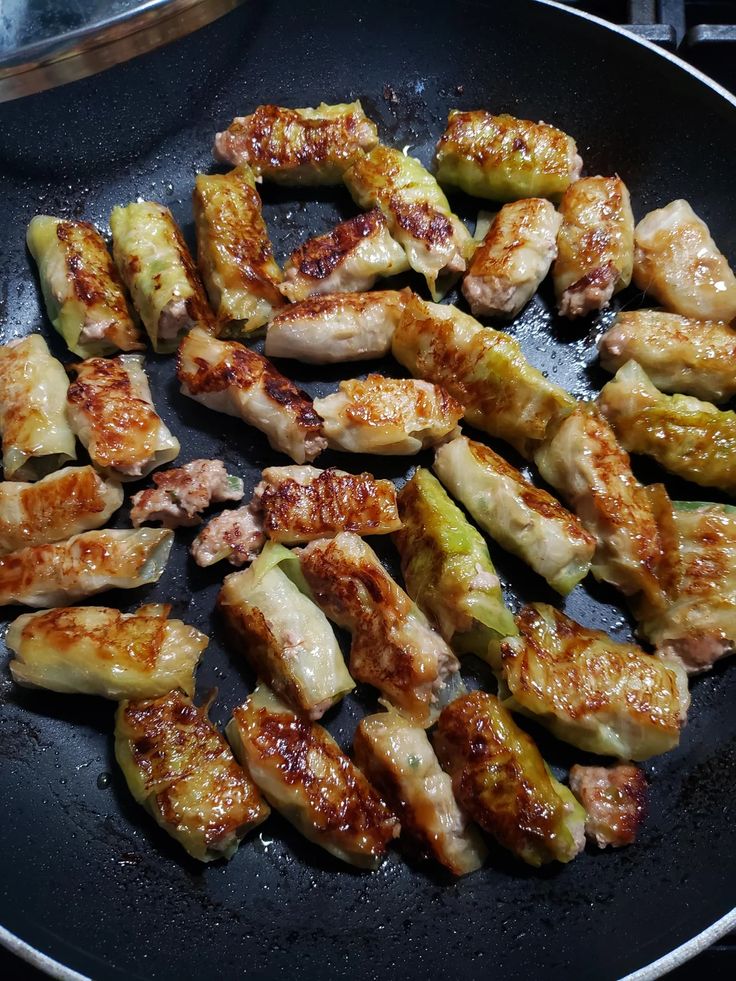 chicken and zucchini being cooked in a skillet