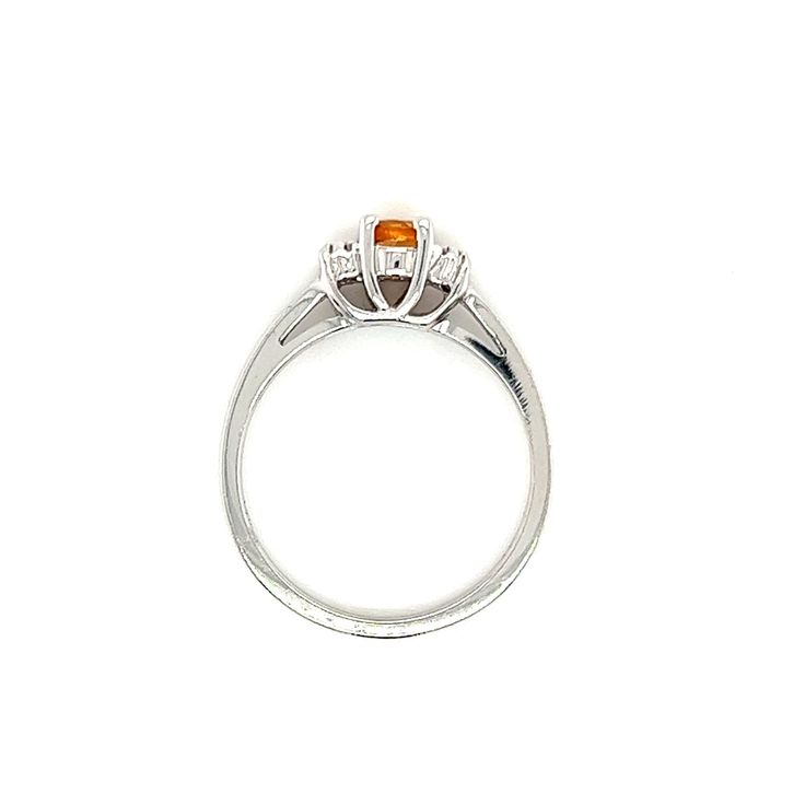 an orange and white diamond ring with three stones on the top, set in 18k white gold