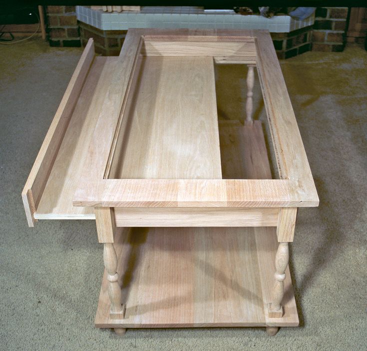 a wooden table sitting on top of a carpeted floor