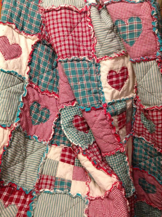 a red and blue quilt with hearts on it